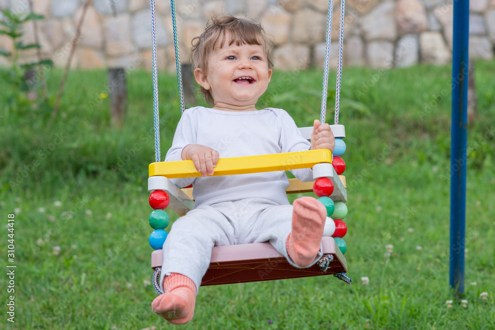 Happy beautiful child on swing Happy beautiful child on swing