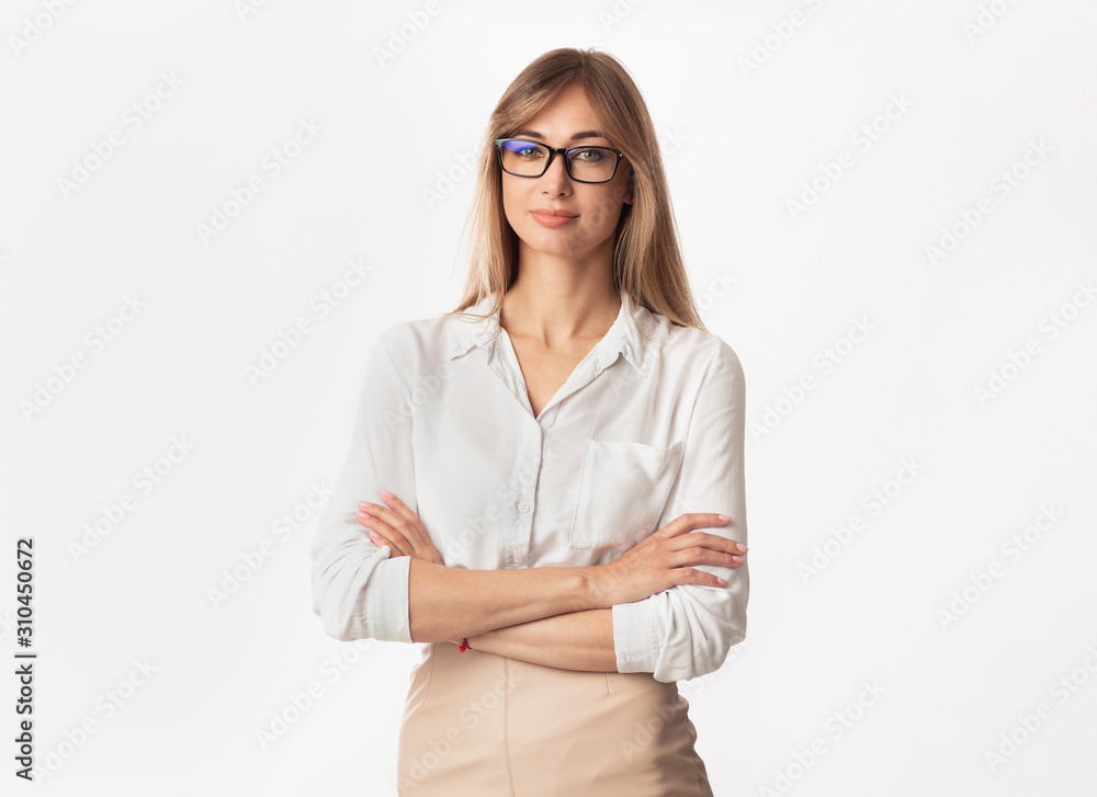 Businesswoman Smiling At Camera Crossing Hands Posing, Studio Shot Businesswoman Smiling At Camera Crossing Hands Posing, Studio Shot