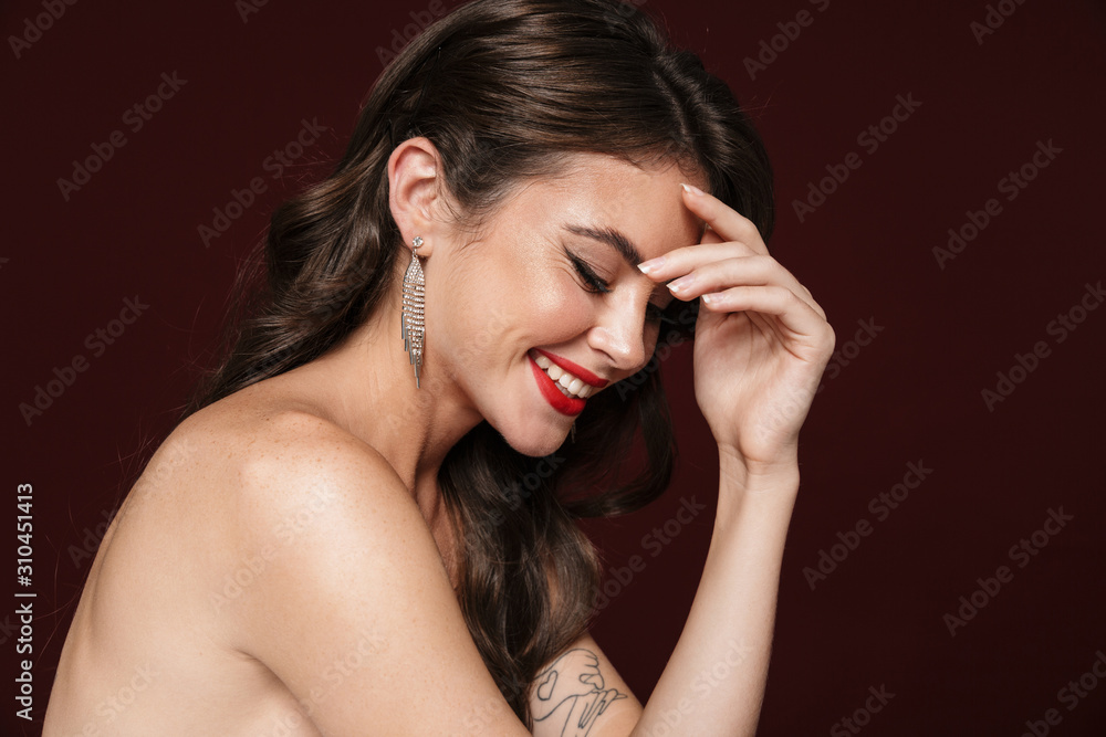 Image of joyful shirtless woman laughing and looking downward Image of joyful shirtless woman laughing and looking downward