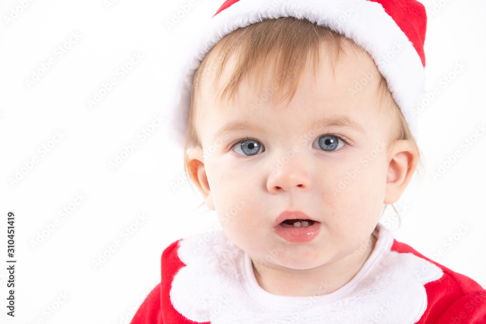 Studio photo with a white background of the portrait of a baby dressed as Santa Claus Studio photo with a white background of the portrait of a baby dressed as Santa Claus