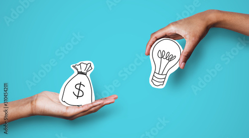 Hands with dollar sign bag and white light bulb photo