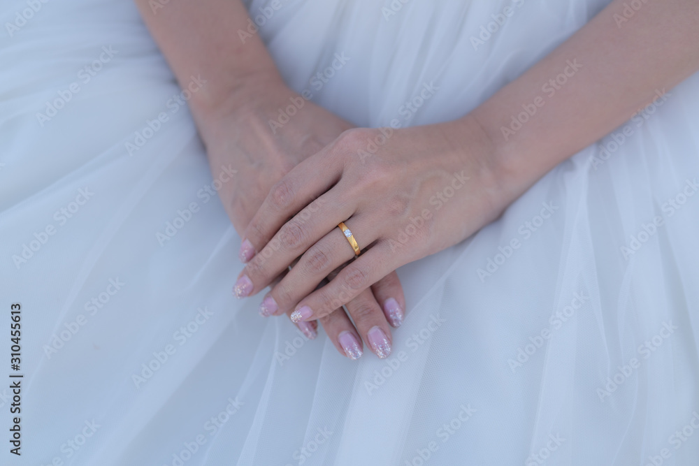Close up and selective focus at golden-diamond ring which is wear on bride's finger. Wedding or married , happiness moment concept photo. Close up and selective focus at golden-diamond ring which is wear on bride's finger. Wedding or married , happiness moment concept photo.