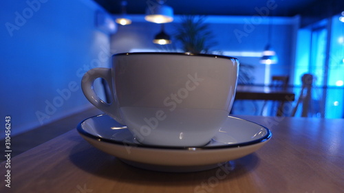 Big white cup of coffee or cappuccino drink on a table in a restaurant