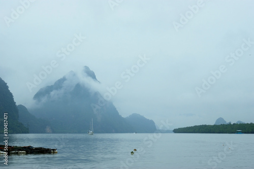 A lonely sail in the mist of the blue sea. What is he looking for in a distant land, what did he throw in his native land? A lonely sailing boat sails in the mist among the mountains at dawn.