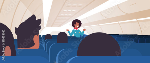 stewardess explaining instructions for passengers african american flight attendant in uniform showing emergency exits safety demonstration concept airplane board interior horizontal vector