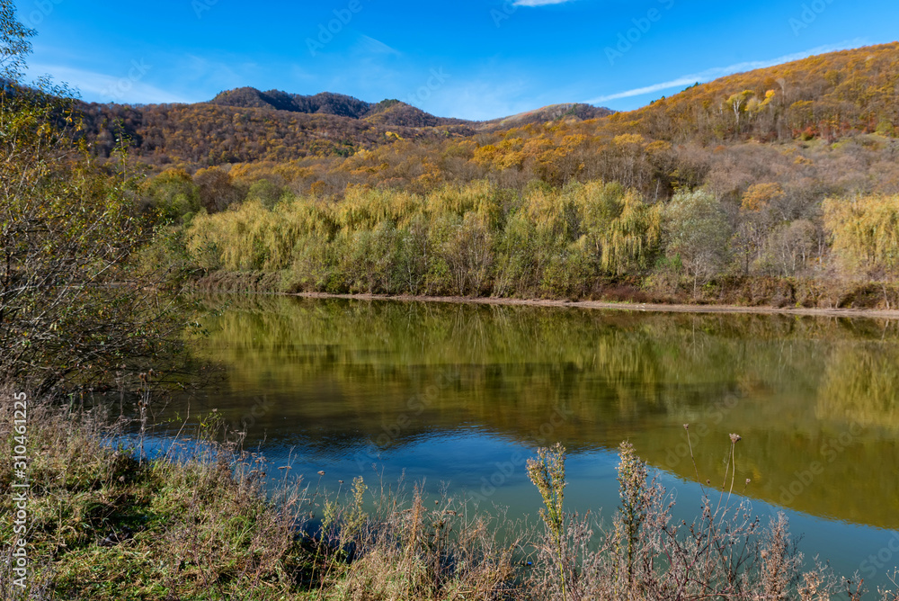 Beautiful autumn landscape with peaceful lake in North Caucasus