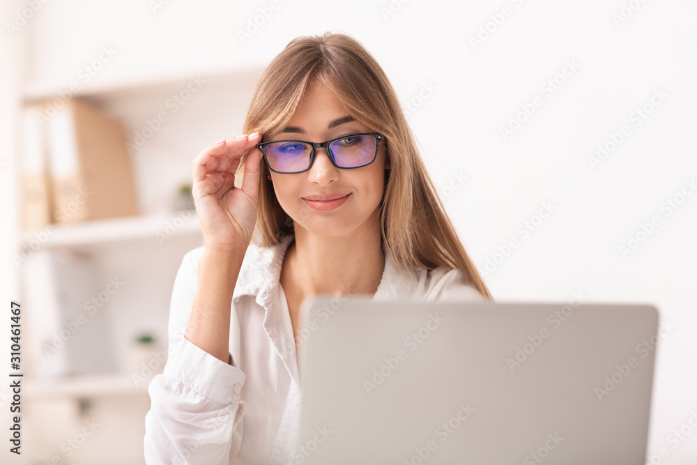 Woman In Eyewear Using Laptop Working In Office Woman In Eyewear Using Laptop Working In Office