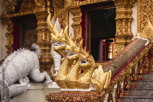 Statue of Naga Serpent with three heads in the stairs to Wat Buppharam Buddhist temple in Chiang Mai, Thailand