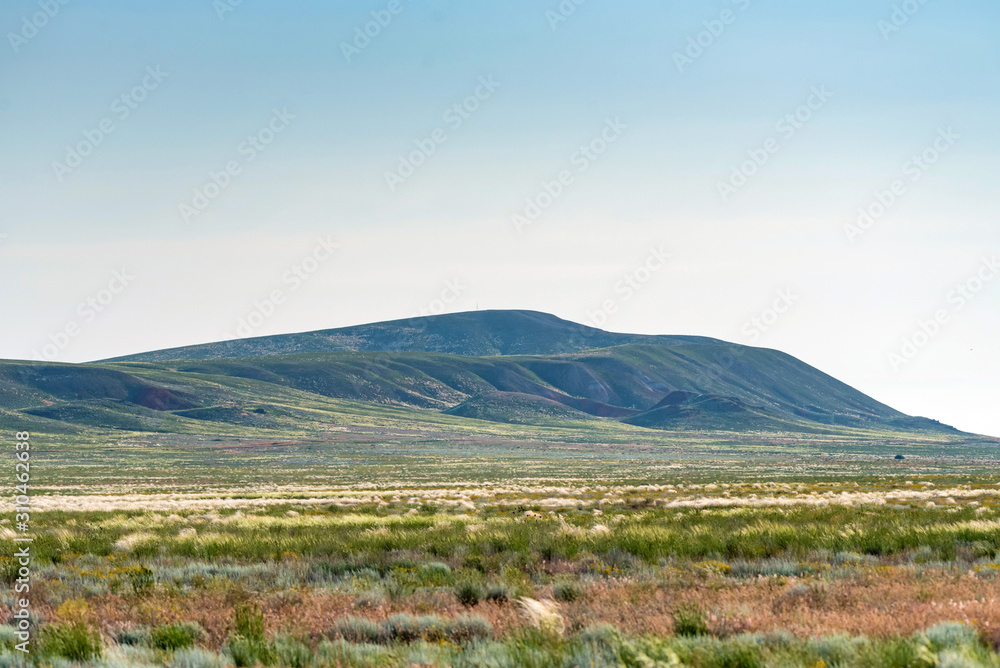 Fototapeta premium Amazing distant landscape of mountain Big Bogdo against sky. Russia