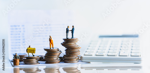 Miniature people standing on a pile of coins. Inequality and social class. Income and economic inequality concept. Inequality in social class, ideology, Gender, Racial and ethnic and health. photo