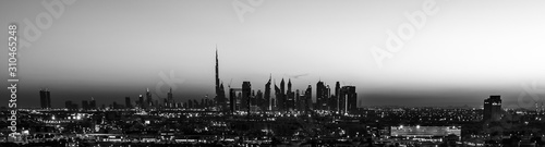 Dubai sunset in black and white view from the creek and sihouette of the cityscape  photo