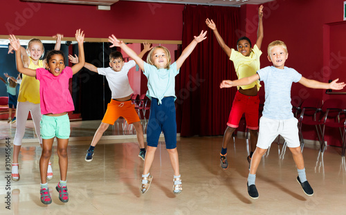 Glad children jumping while studying dance