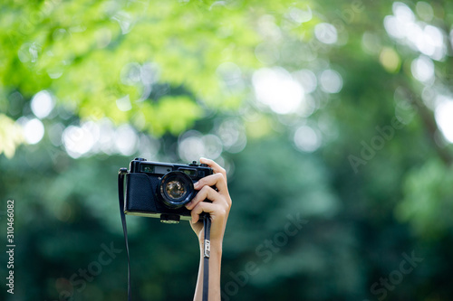 Photographer and camera lover Black camera and natural green background