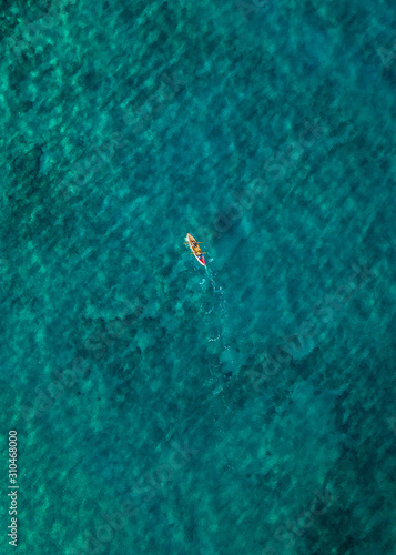 The bright, crystal clear waters off the coast of the island of Maui with a drone, birds eye view