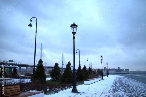 promenade with lanterns on a dark winter evening