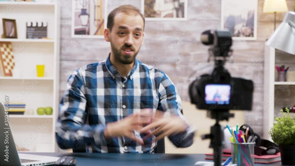 Excited influencer while recording for his vlog in living room Excited influencer while recording for his vlog in living room