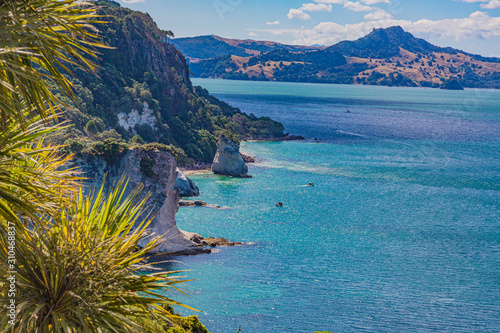 View over cliffy shore of Te Whanganui-A-Hei Marine Reserve on Northern island in New Zealand in summer photo