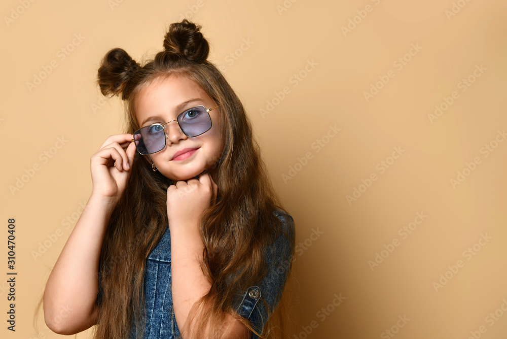 Cute girl in jeans sundress and sunglasses posing on camera. Cute girl in jeans sundress and sunglasses posing on camera.