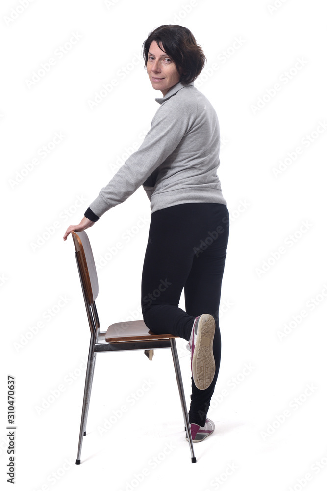 woman standing with a chair in white background woman standing with a chair in white background