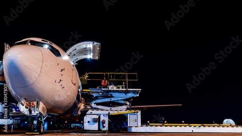 freighter aircraft loading cargo at night