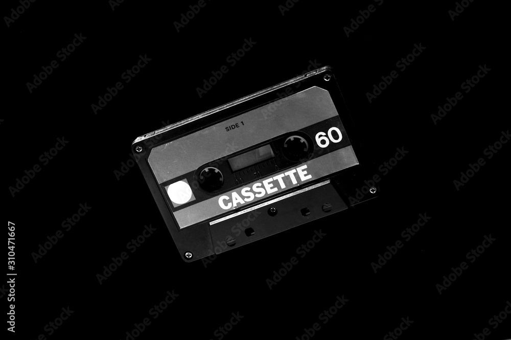 Obraz premium old black audio cassette on dark background