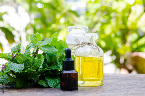 Peppermint essential oil is empty on the table and essential oil bottles - healthy ideas