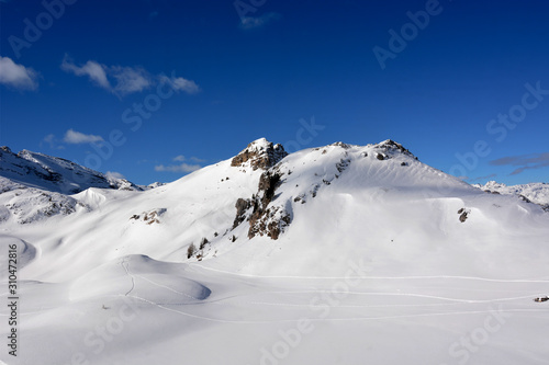a clear day on the snow in the high mountains © corradobarattaphotos