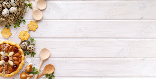 Easter background with  mazurek pastry and quail eggs on rustic white wooden background, top view, copy space. Traditional Easter 