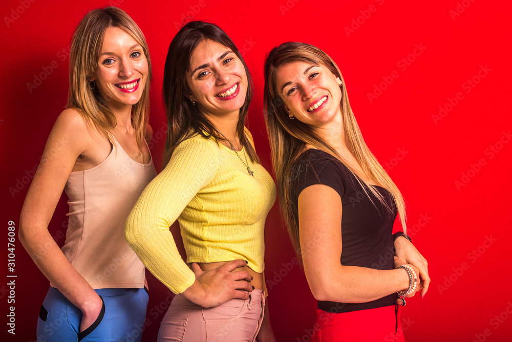 Three girls smiling one behind the other in line Three girls smiling one behind the other in line
