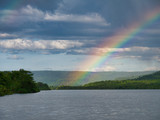 After heavy rain a rainbow forms over the river at Tatai in Koh Kong Province, Cambodia