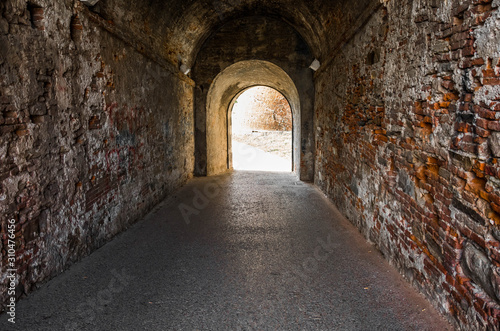 Old brick archway as a passage between the two wings of a medieval castle