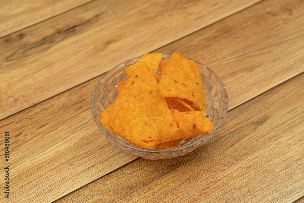 Plate with tasty nachos with wooden background Plate with tasty nachos with wooden background