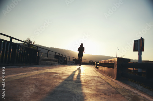 Young runners run on the runway during the evening hours..Healthy jogging concepts (silhouette)