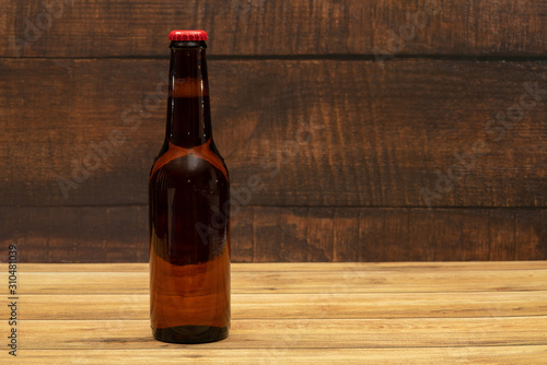 Beer bottle with wooden background