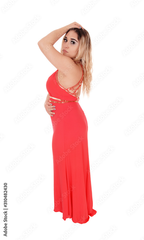 Beautiful blond woman standing in red dress with hand on head Beautiful blond woman standing in red dress with hand on head