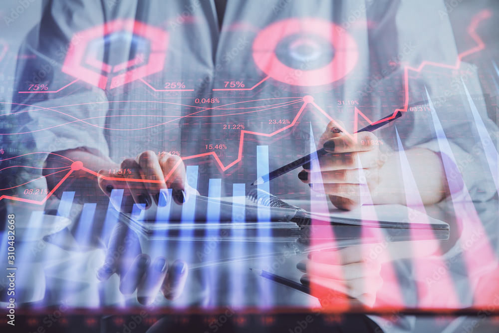 Financial forex graph drawn over hands taking notes background. Concept of research. Double exposure Financial forex graph drawn over hands taking notes background. Concept of research. Double exposure