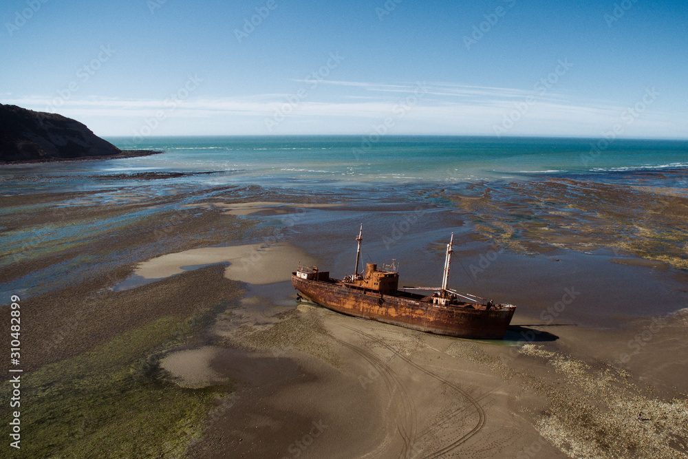 Aerial view of Old ship Desdemona, shipwreck, run aground on the ocean coast