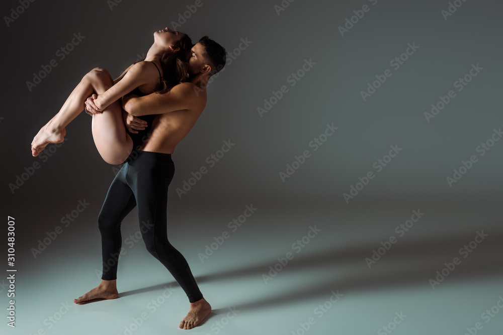 sexy dancers dancing contemporary on dark background with copy space sexy dancers dancing contemporary on dark background with copy space