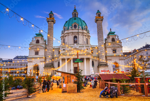 Festive cityscape - view of the Christmas Market on Karlsplatz (Charles' Square) and the Karlskirche (St. Charles Church) in the city of Vienna, Austria photo