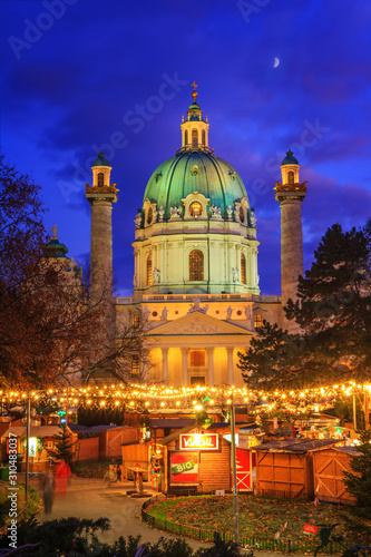 Festive cityscape - view of the Christmas Market on Karlsplatz (Charles' Square) and the Karlskirche (St. Charles Church) in the city of Vienna, Austria