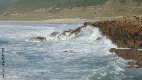 Waves breaking against the cliffs. Nemiña beach, in Atlantic Galician Coast, Spain.