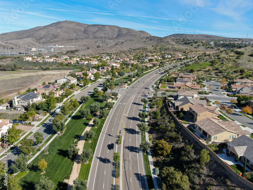 Aerial view of neighborhood with residential modern subdivision luxury houses and small road during sunny day in Chula Vista, California, USA.