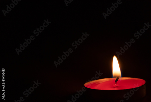 Red candles on a black background. Fire in the dark. Candle light. Light it up. Forever.