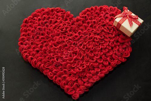 Valentine s Day. Red and white hearts on craft paper background. Beautiful red heart of roses  felt handmade. Black.