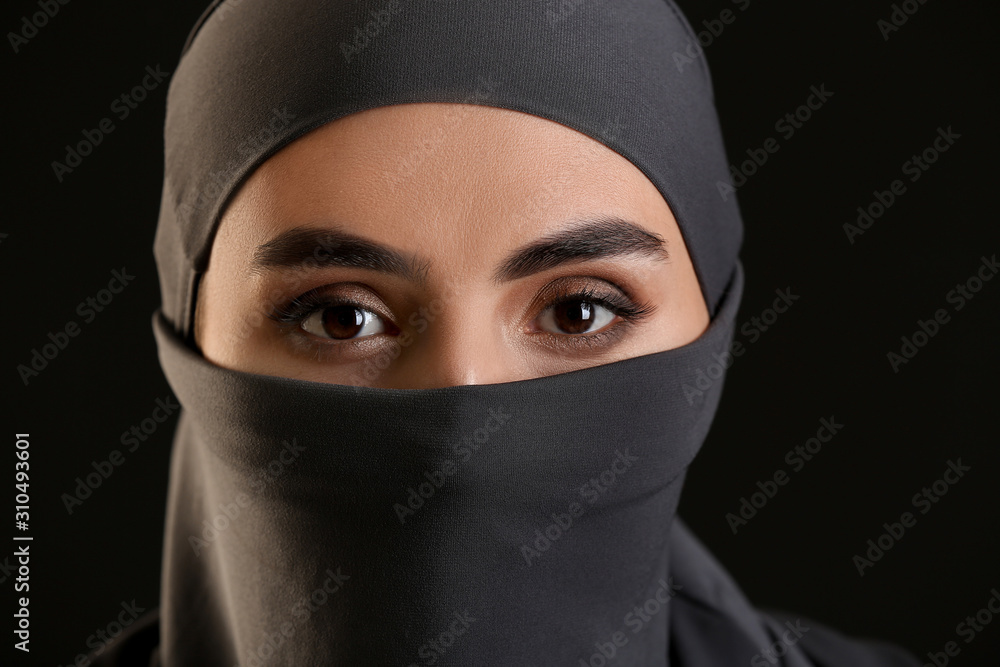 Beautiful Arab woman on dark background, closeup Beautiful Arab woman on dark background, closeup