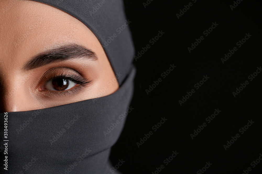 Beautiful Arab woman on dark background, closeup Beautiful Arab woman on dark background, closeup