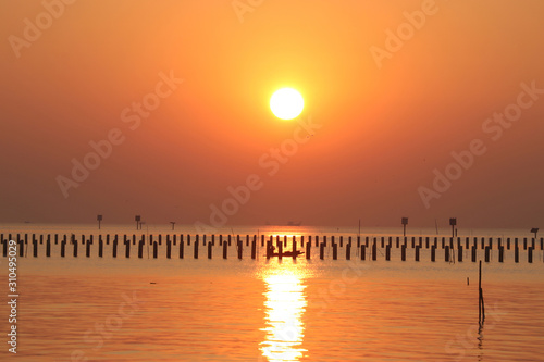 The morning sunrise is a golden light reflecting the sea water.