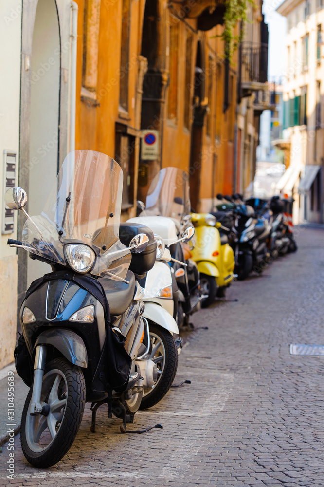 Old street with motorbikes. Architecture and transport in Padua, Italy. Italian cozy and colorful street.