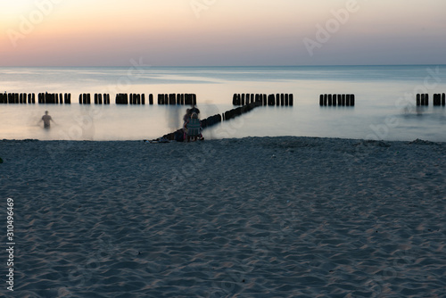 Wooden breakwater at sunset on the Baltic Sea photo