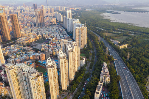 an aerial view of a coastal residential community near the highway in shenzhen, china
